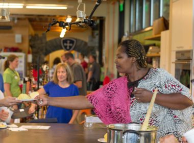 Antoinette Murekatete serving food at a ReEsthablish Richmond event