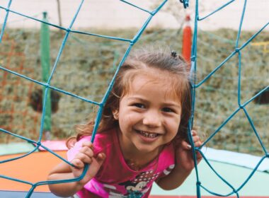 Little girl smiling outside