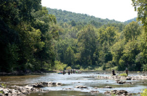 People fishing and wading in Charlottesville’s Rivanna River