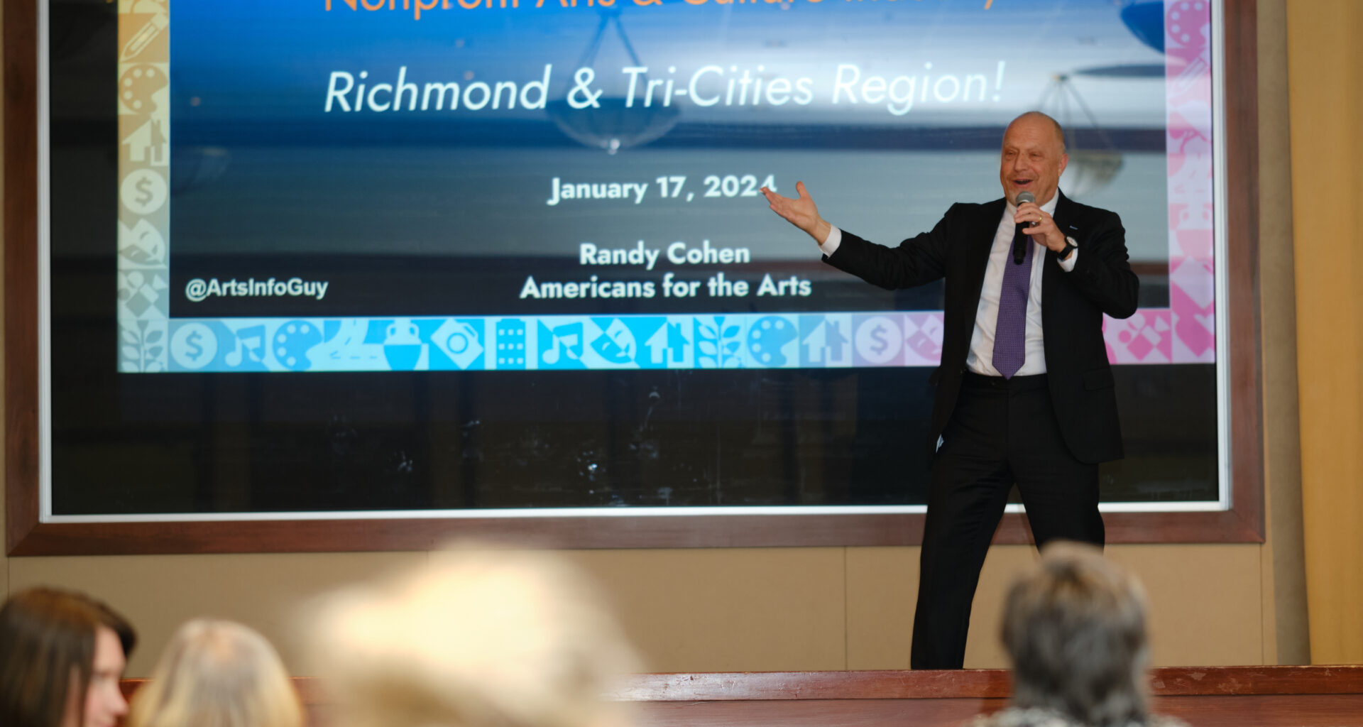 Randy Cohen presents the study's findings on stage.