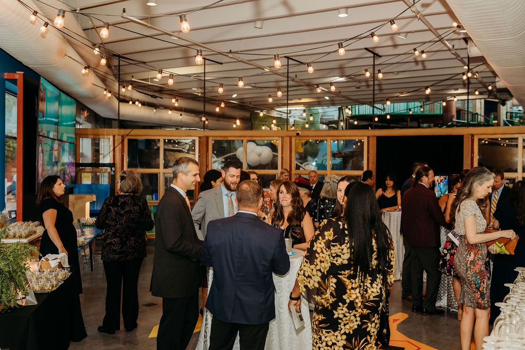 People enjoying food at the Pretend Again event hosted by the Children's Museum of Richmond