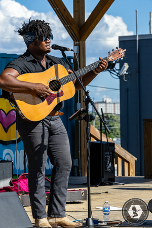 Jonathan Paige Brown Jr. playing guitar on stage.