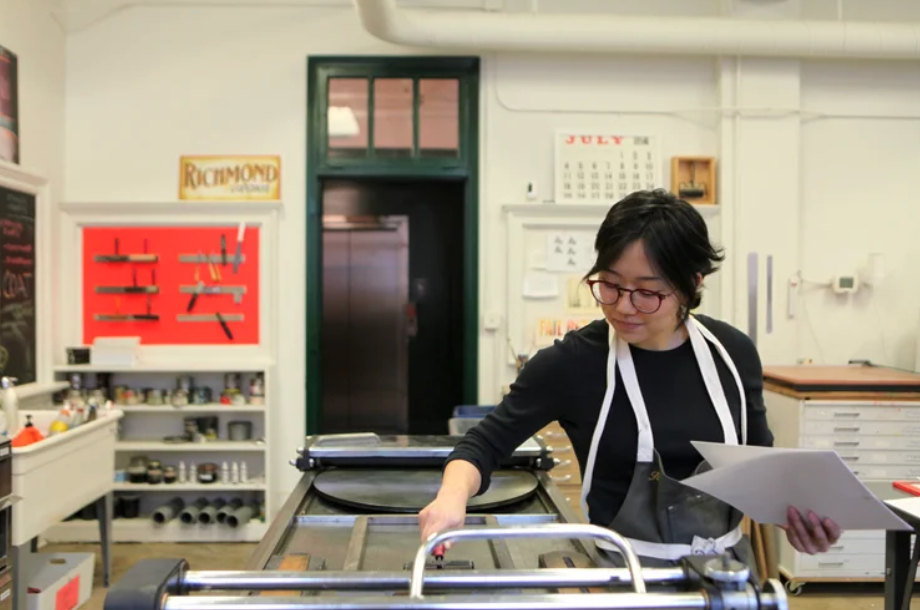 artist working with screen printer
