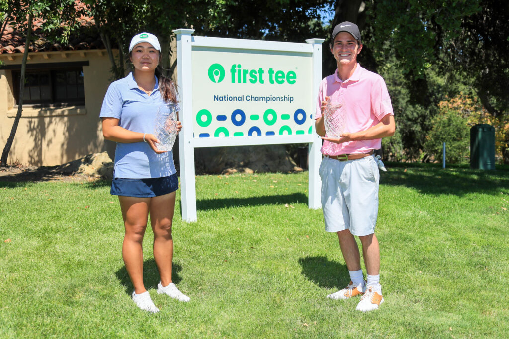 Two teenagers holding trophies at the First Tee National Championship Tournament