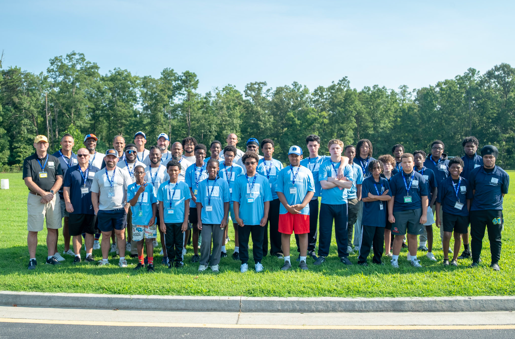 Large group of men and boys gathering for a photo during the 2026 summer camp program